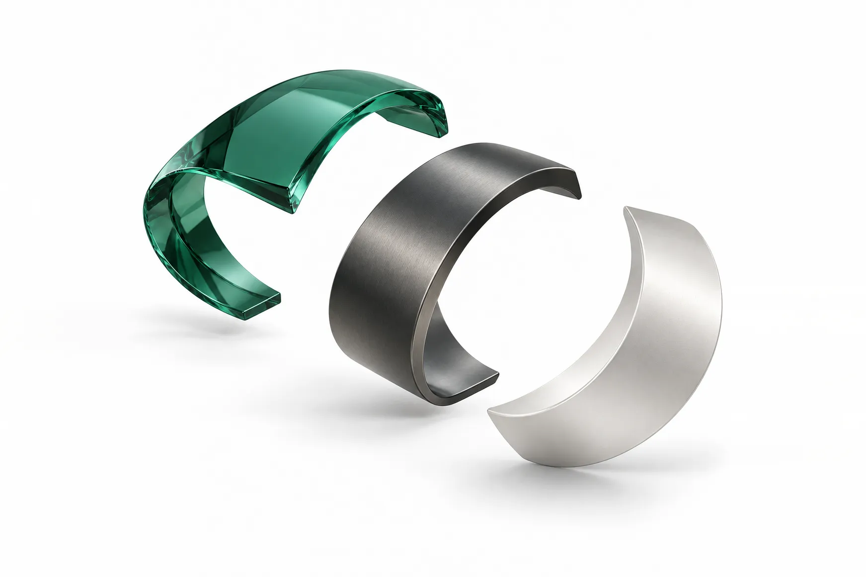 Abstract arrangement of separated green glass, dark gray, and silver arcs